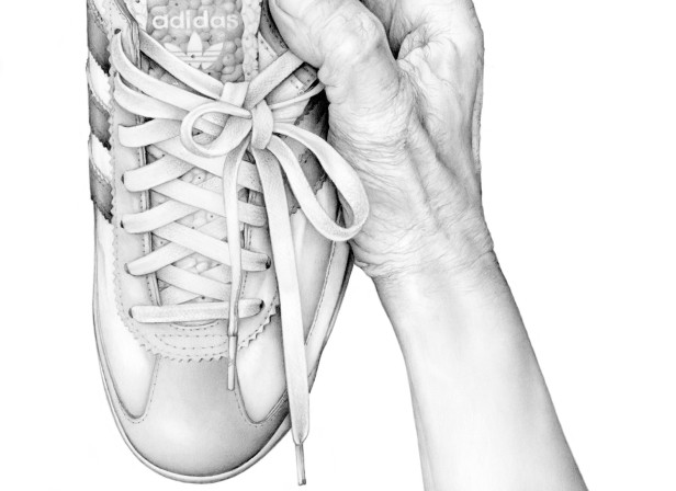Hand Holding Adidas Trainer